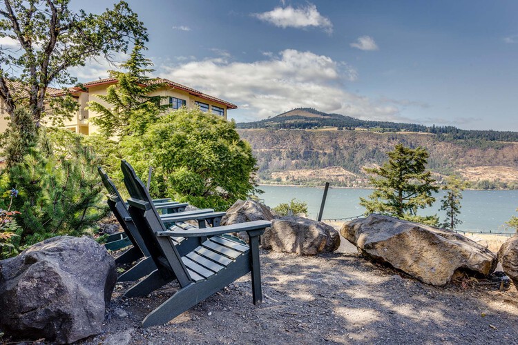 Two outdoor chairs overlooking the river