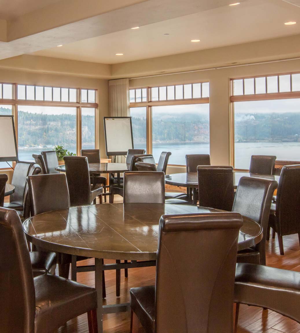 Meeting space with multiple round tables and whiteboards
