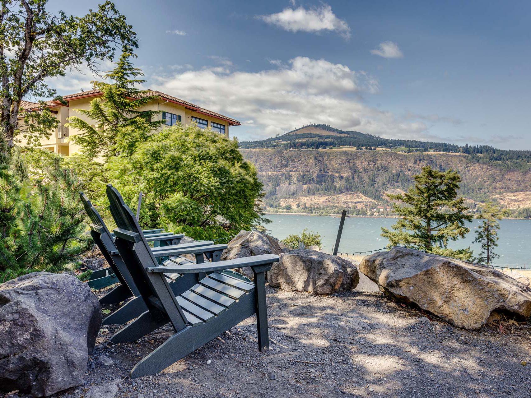 Two lawn chairs outdoors near the river